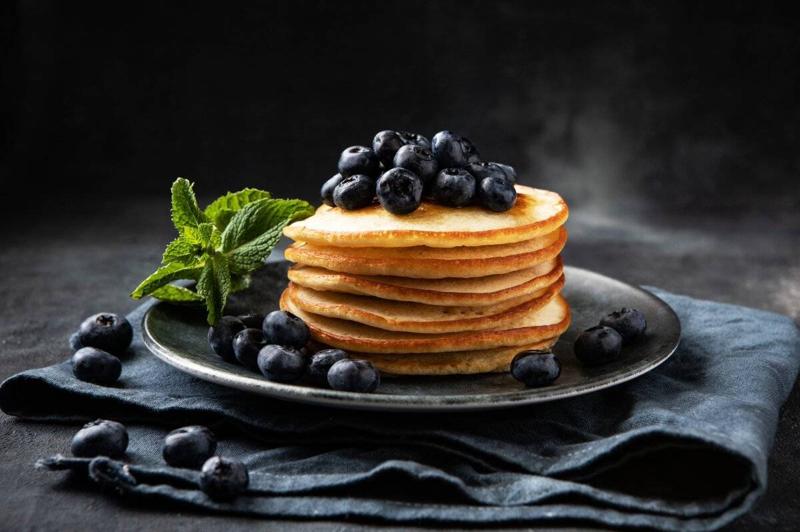 Dessert plate with pancakes and fresh blueberries,  selective focus with shallow depth of field